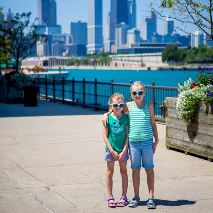 Two young girls standing in front of the Chicago skyline.