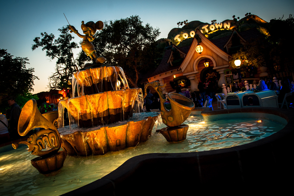 ToonTown at night, the water fountain is in the foreground.