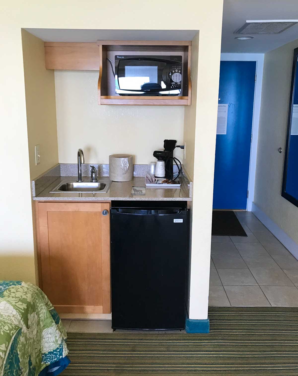 The kitchenette in a family-friendly hotel room.