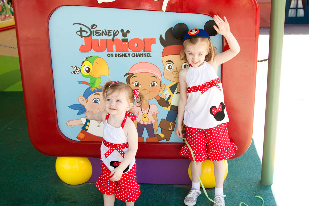 A toddler and a preschooler in Mickey mouse outfits.