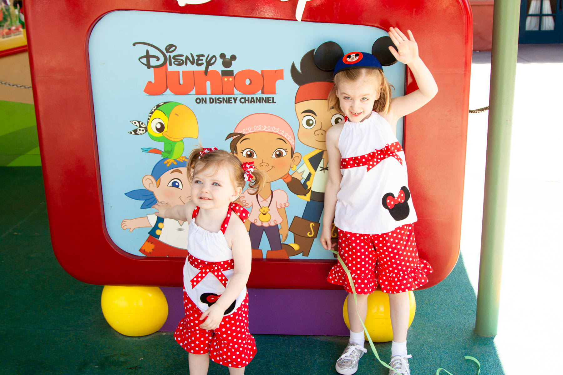 The toddler and her big sis wearing matching outfits at Disney Hollywood Studios.