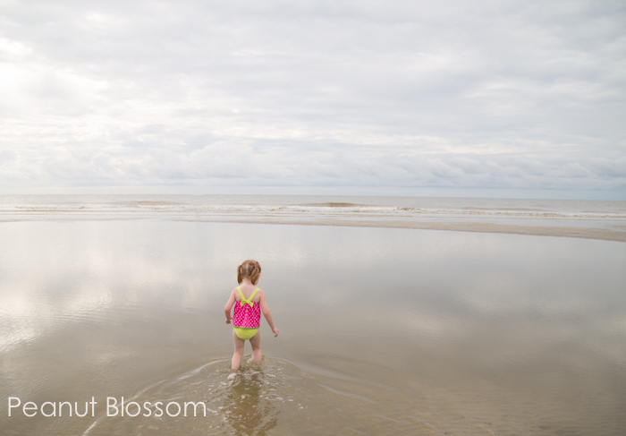 Having a romantic getaway with the kids | Peanut Blossom A little girl is playing in a tidepool at the beach.