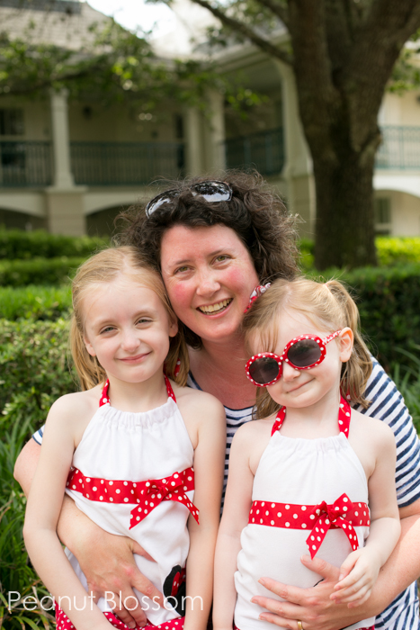 Renting camera gear for vacation | Peanut Blossom A mom cuddles her two daughters during a Disney vacation.