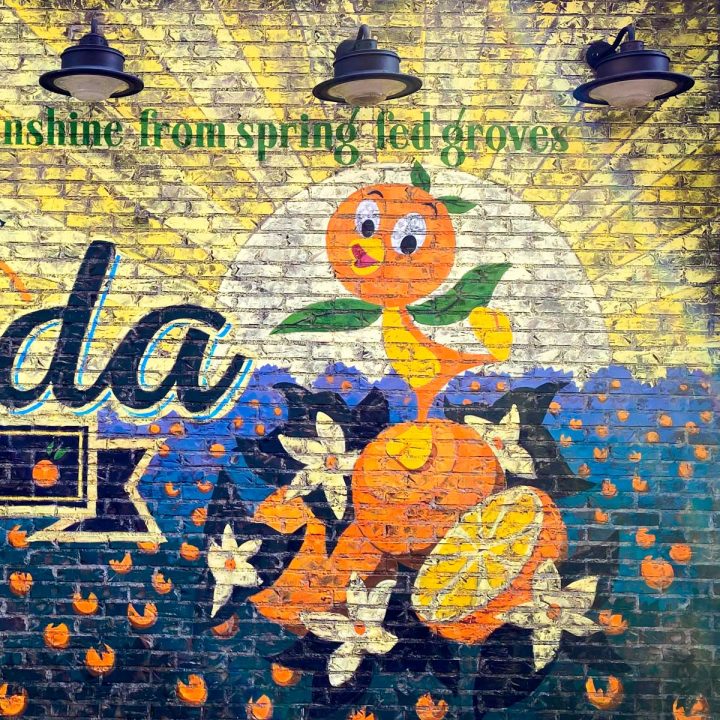 A mural on the brick wall shows Orange Bird on top of a few sliced oranges.