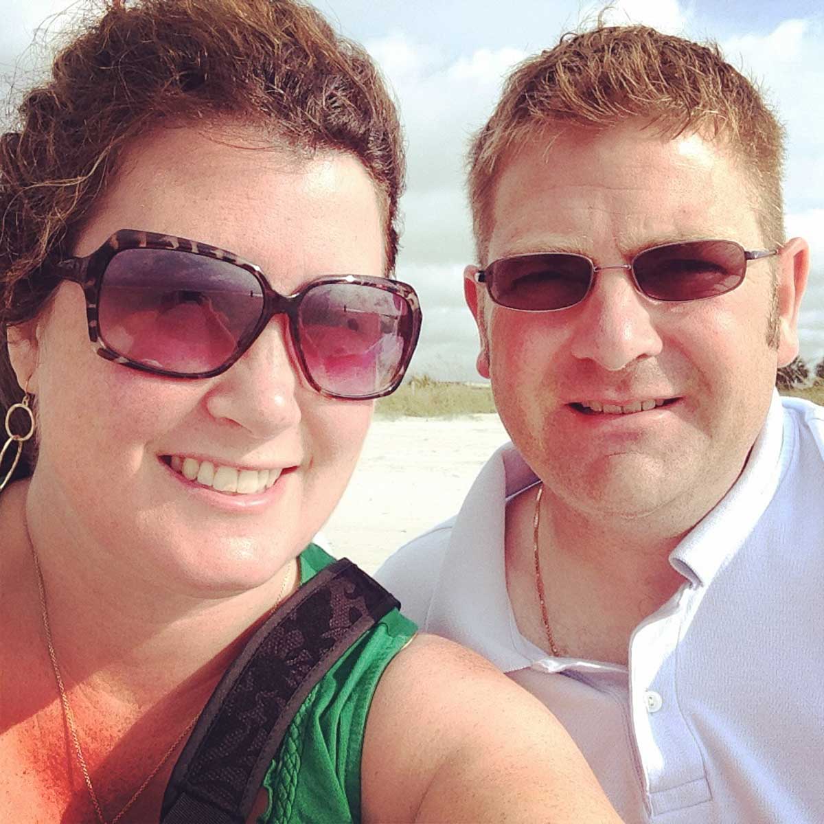 A husband and wife on the beach during a romantic getaway.