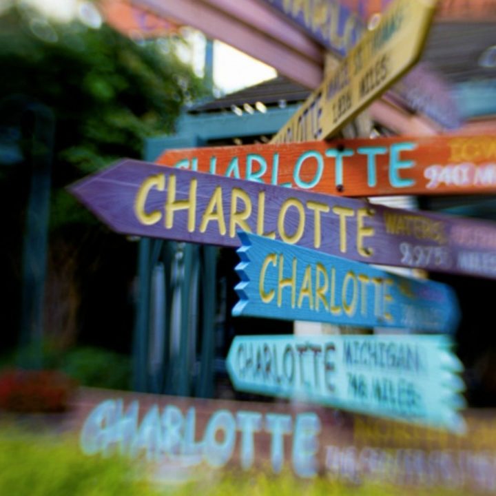 A colorful painted sign says "Charlotte"