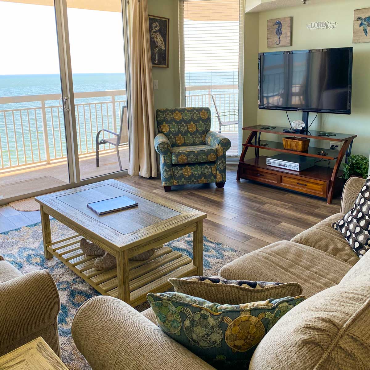 The living room of a beach condo overlooks the ocean.