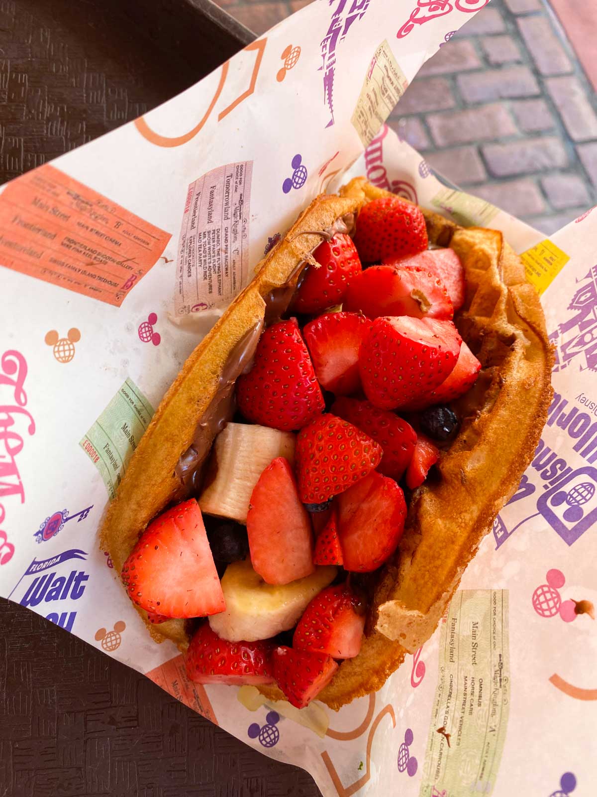 A waffle spread with Nutella and fresh strawberries.