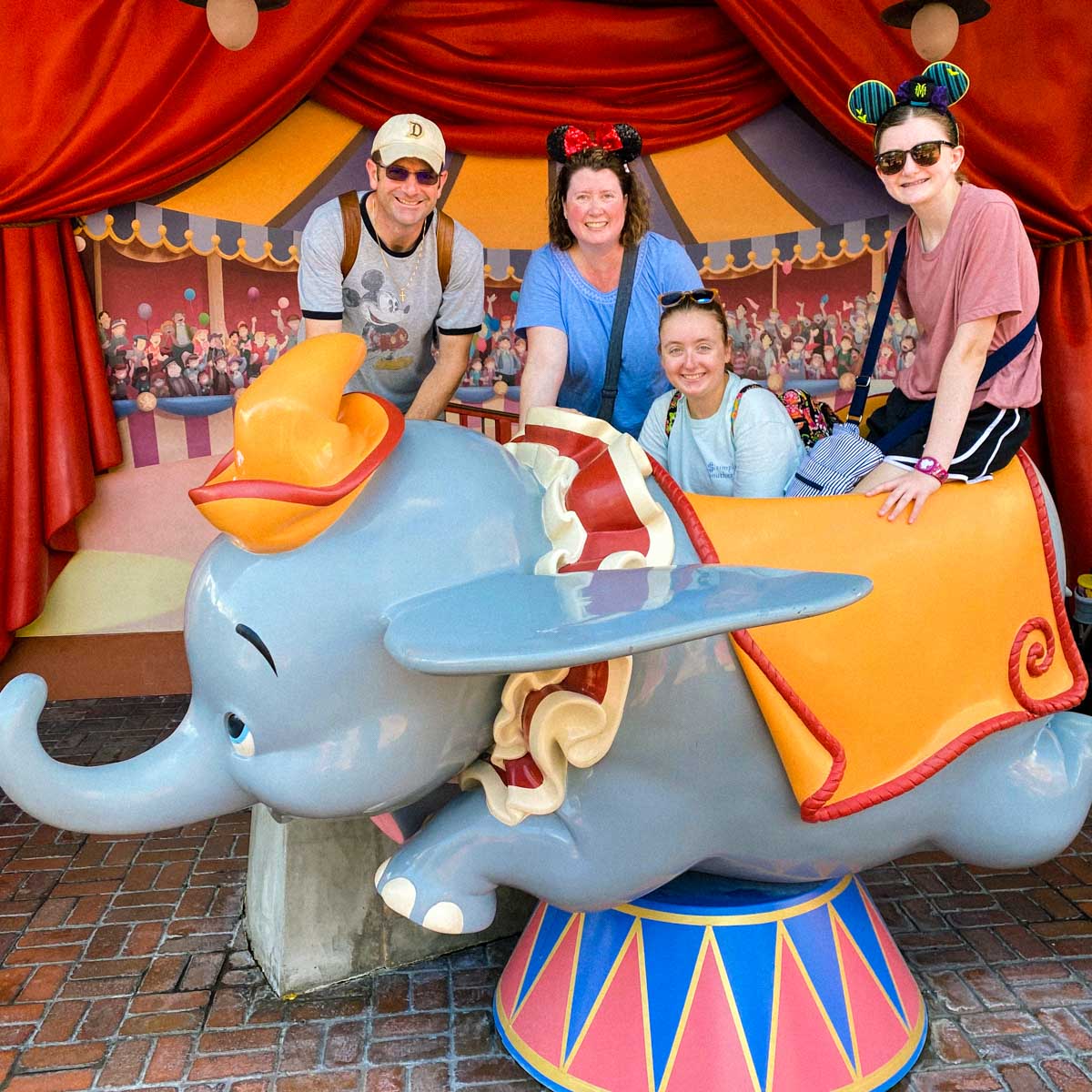 The four family members behind this blog pose with Dumbo at Disney's Magic Kingdom. 