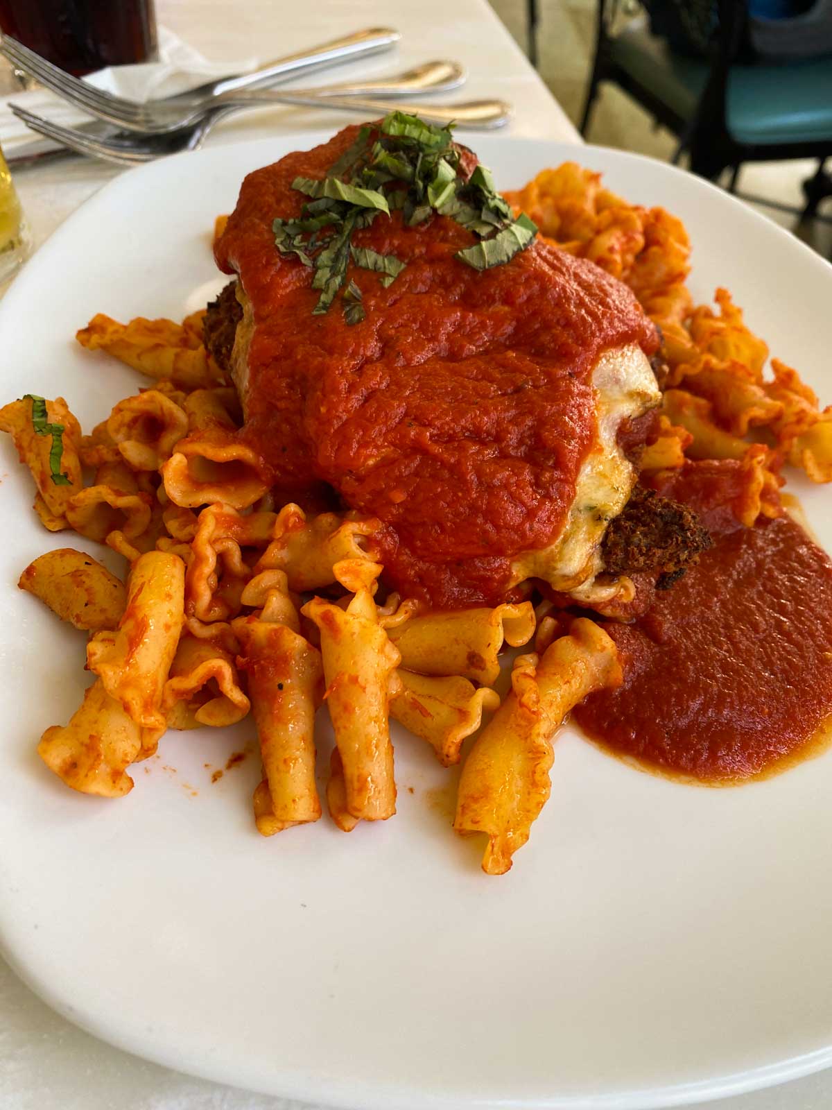 The chicken parmesan is served over campanelle pasta.