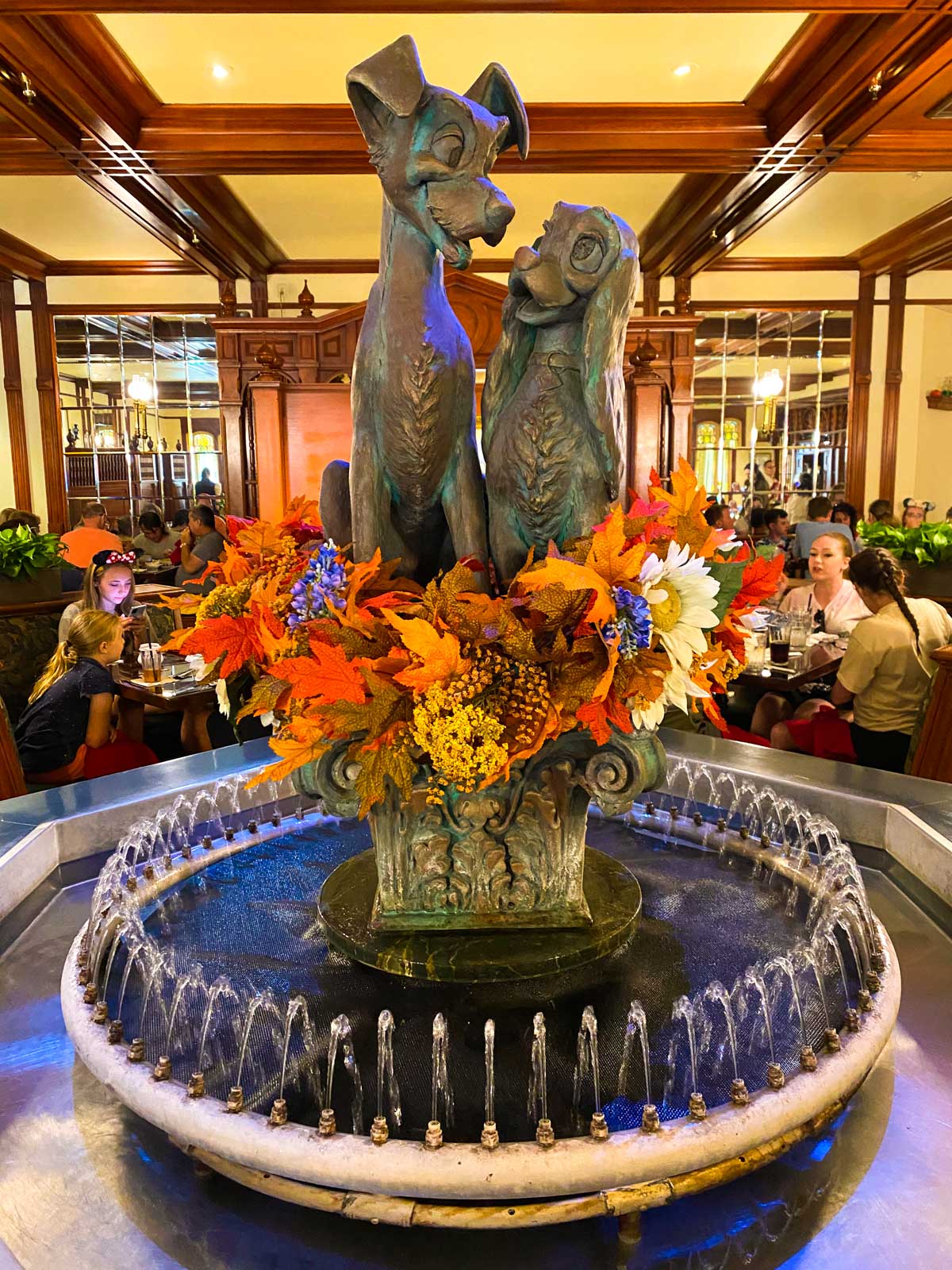 The fountain is decorated with fall flowers.