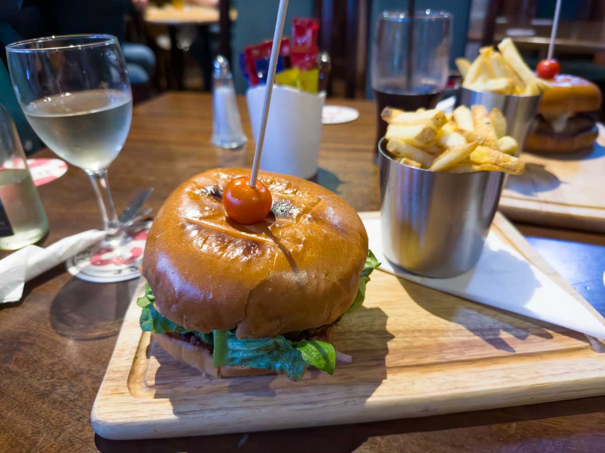A hamburger and chips are served at an Irish pub.