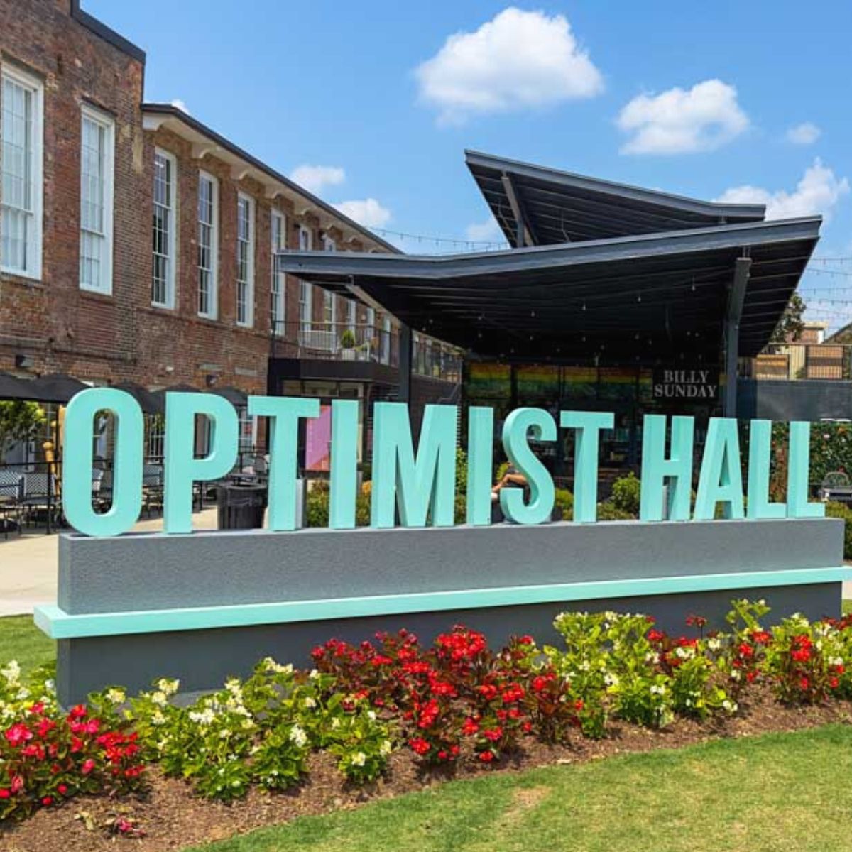 The outside sign in front of Optimist Hall welcomes visitors to the food hall in Charlotte, NC.