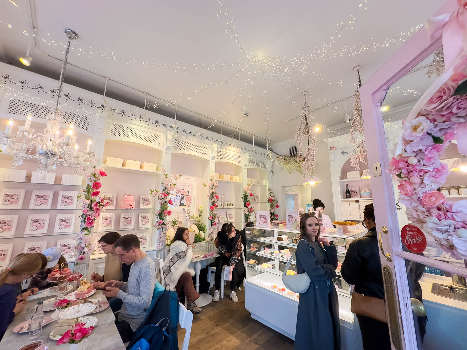 The Peggy Porschen's tea shop in London has twinkle lights on the ceiling and floral decor everywhere.