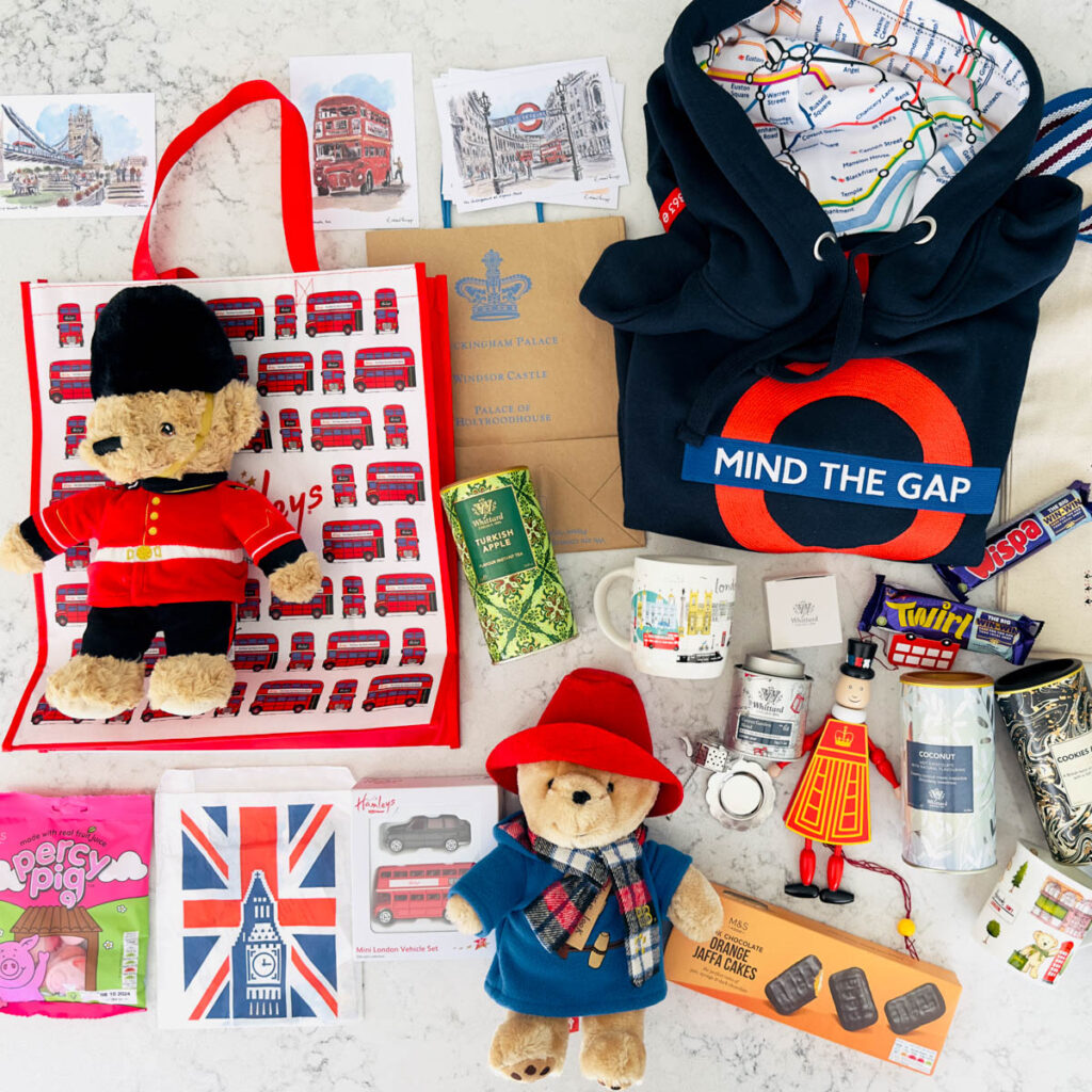 An arrangement of toys, postcards, and foods from london that are perfect for gifts.