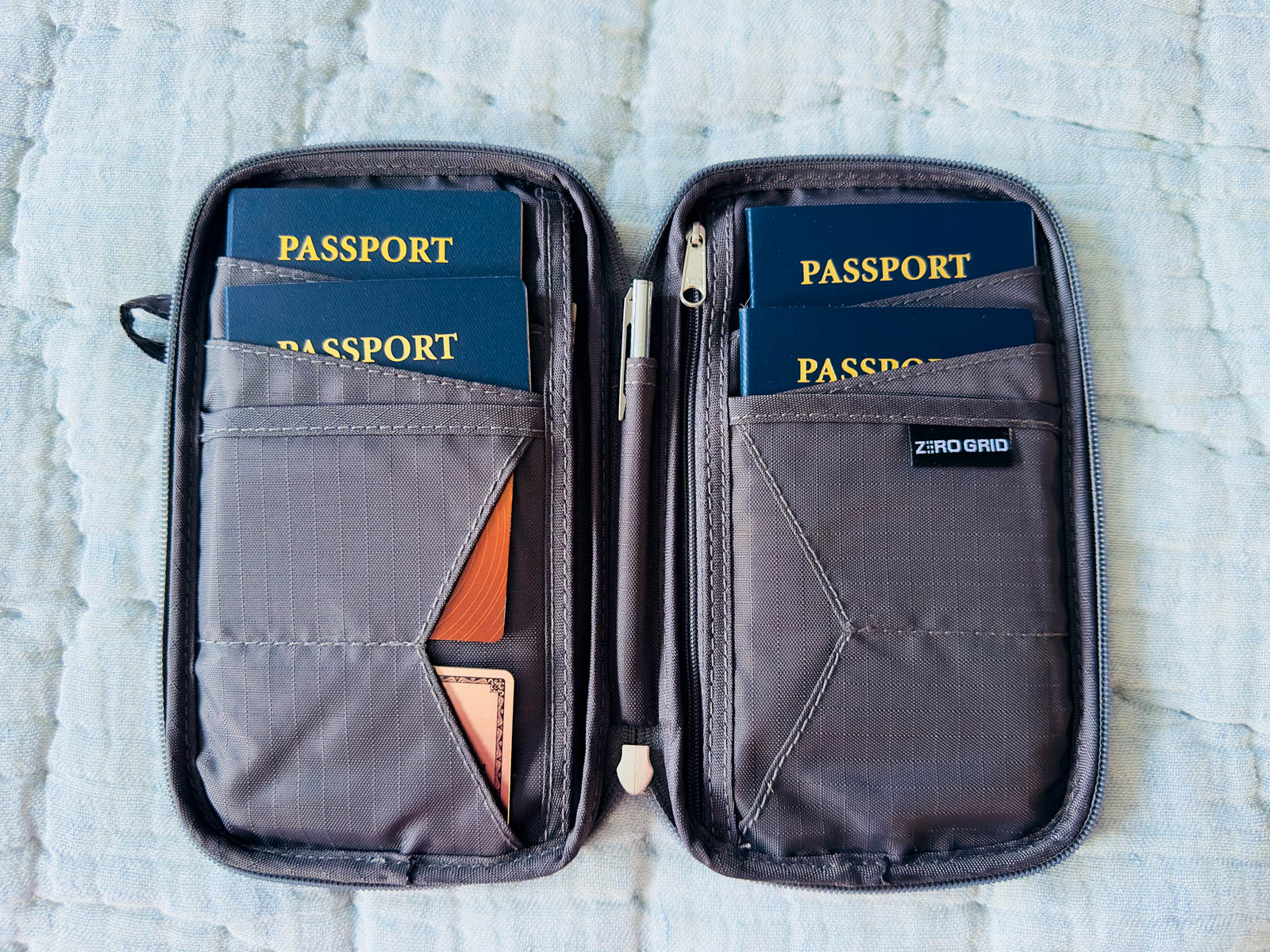 A travel folio is filled with 4 passports and credit cards.