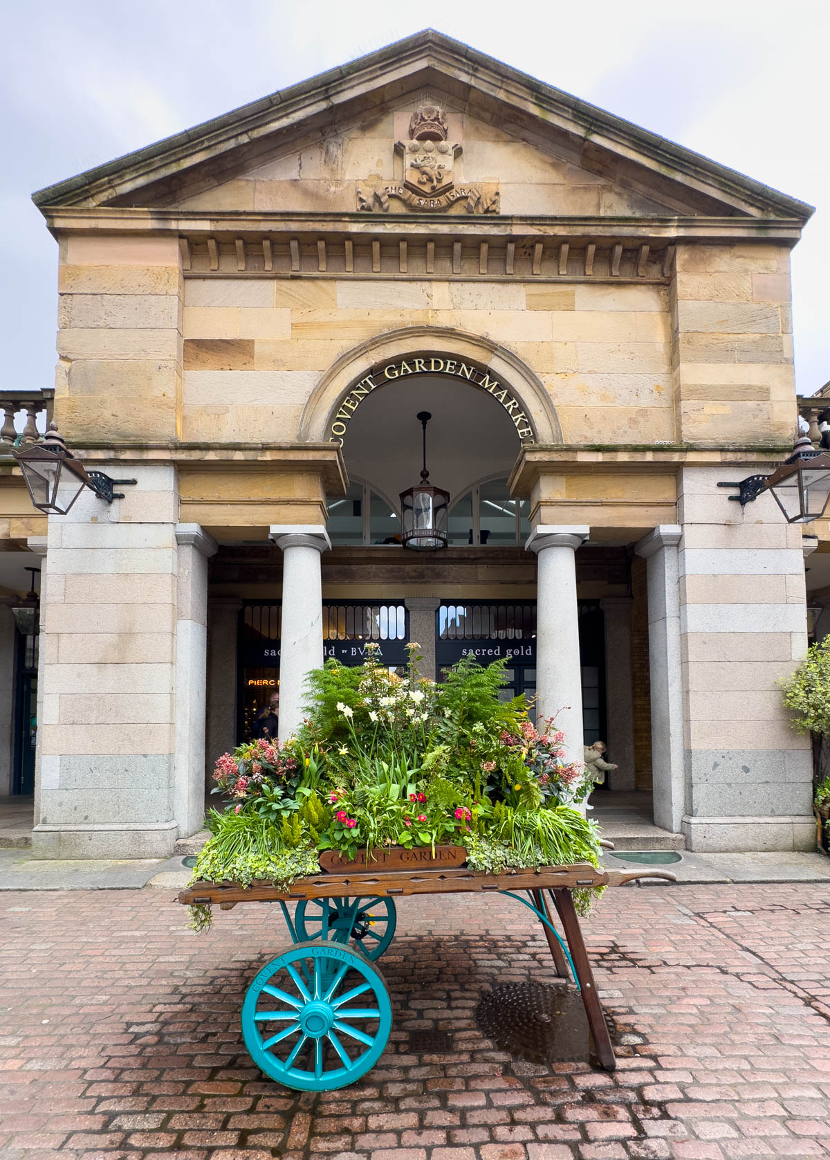 The entrance to Covent Garden has a large floral display in front.