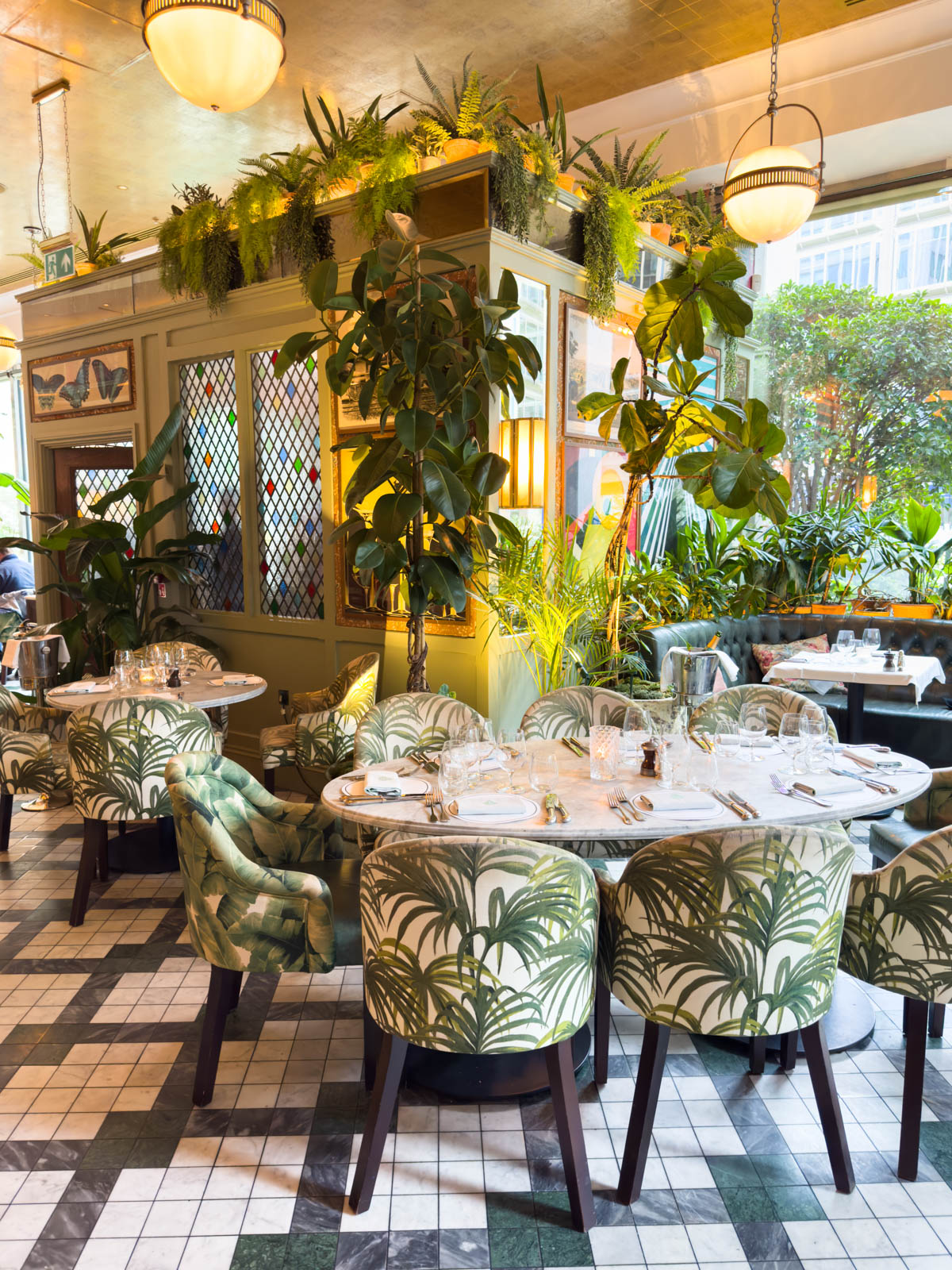 The ivy-covered dining room inside the Ivy restaurant in London.
