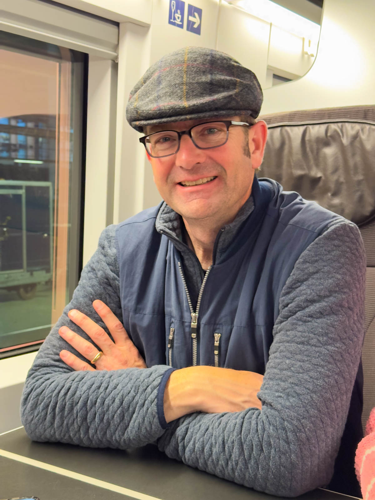 A man in a cap on the train.