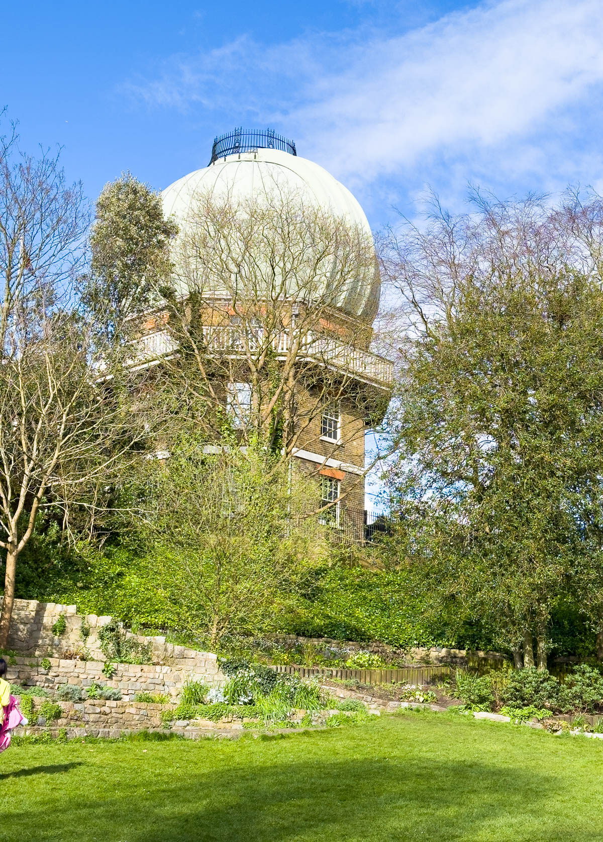 The observatory dome is seen from below in a green park.