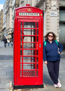The author stands by a classic red phone booth in London.