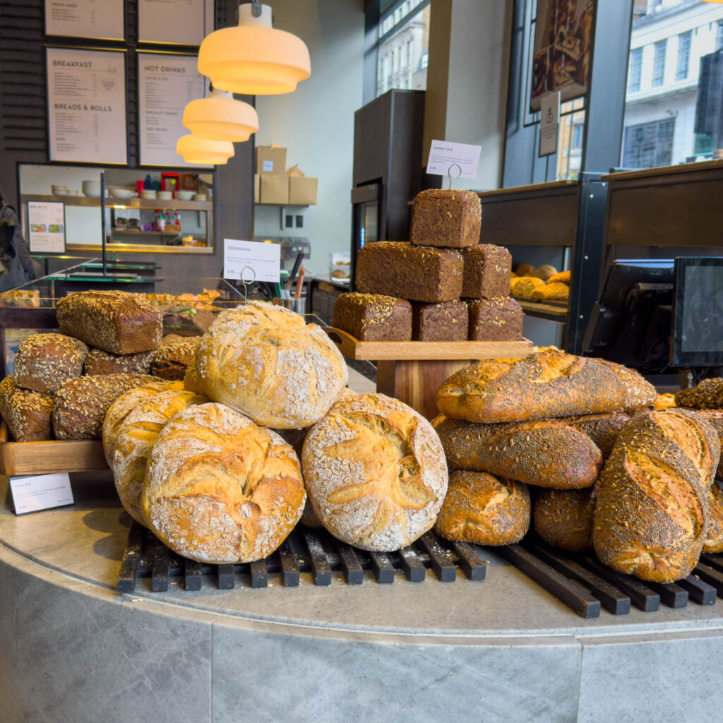 Piles of fresh bread in a bakery in london.