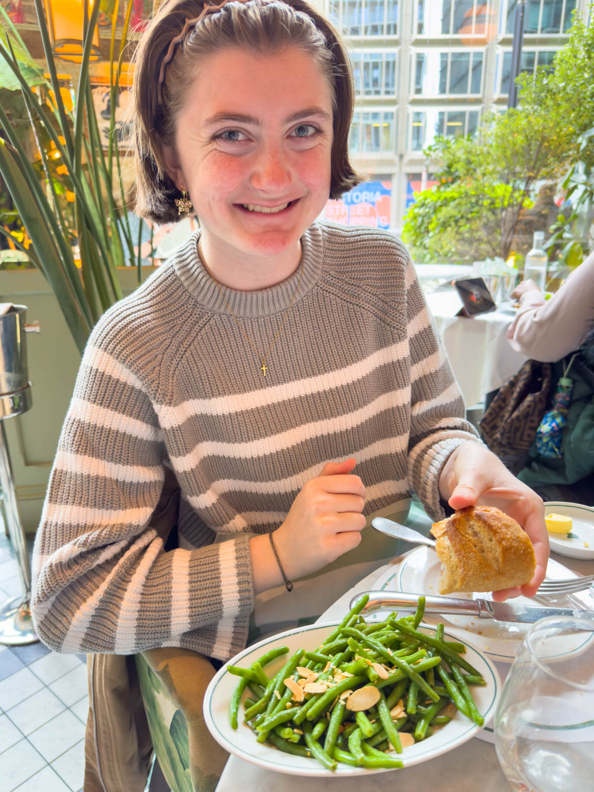 A young girl orders green beans from The Ivy in London.