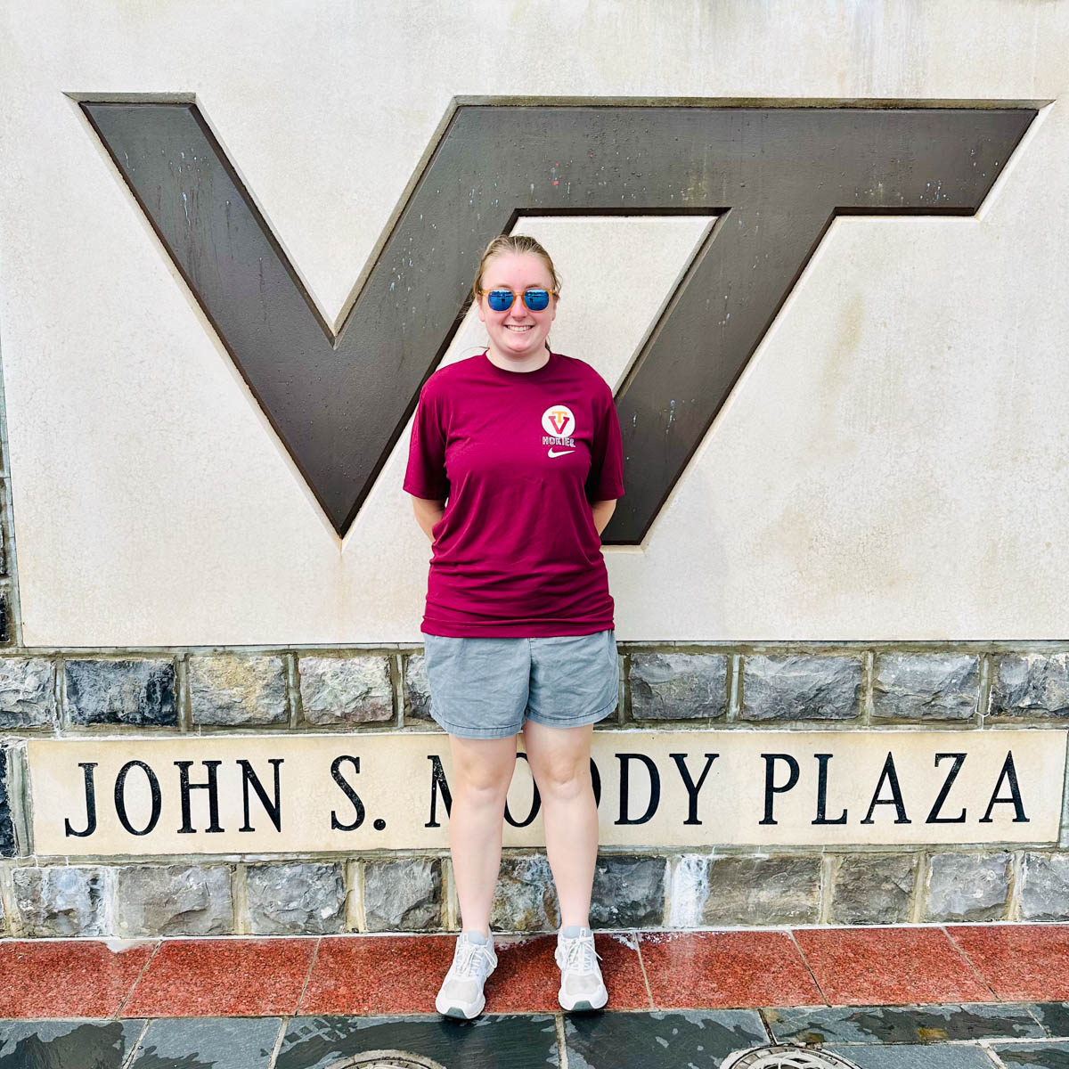 A prospective student stands outside the Virginia Tech stadium. 