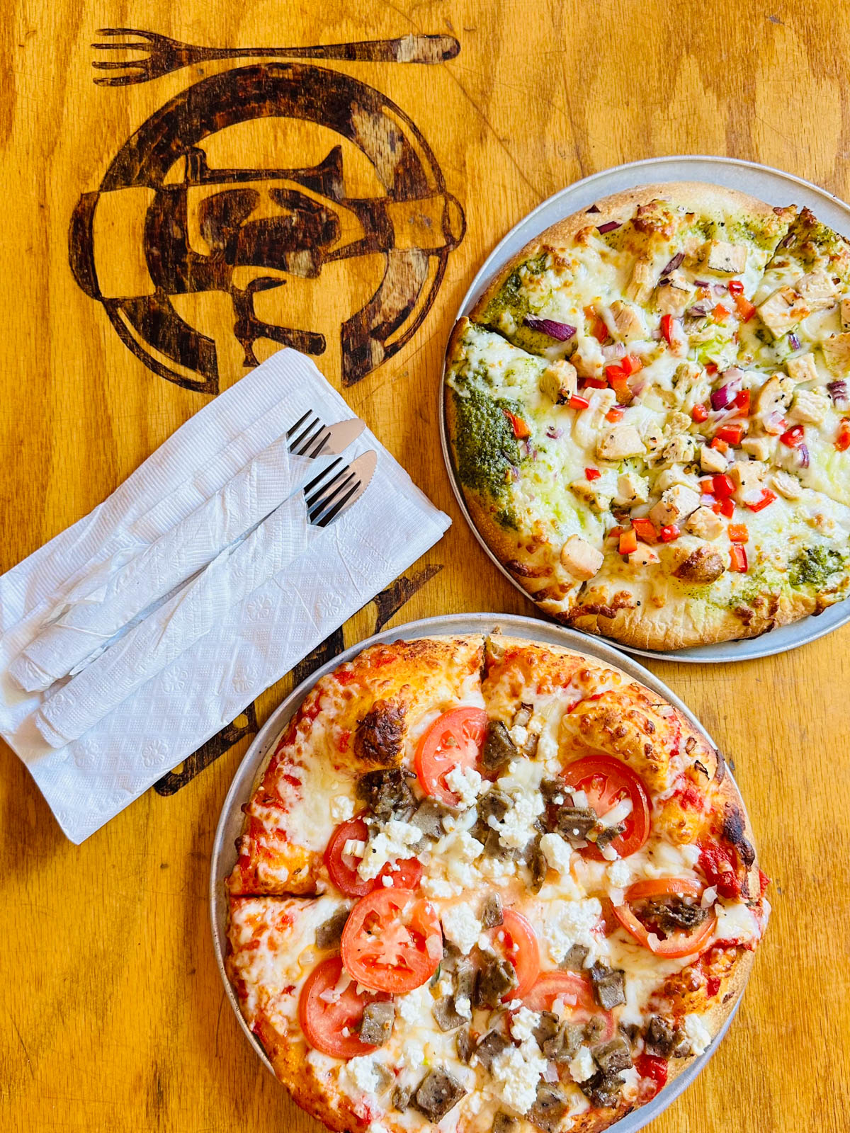 Two pizzas on a table inside The Cellar restaurant in Blacksburg, VA.