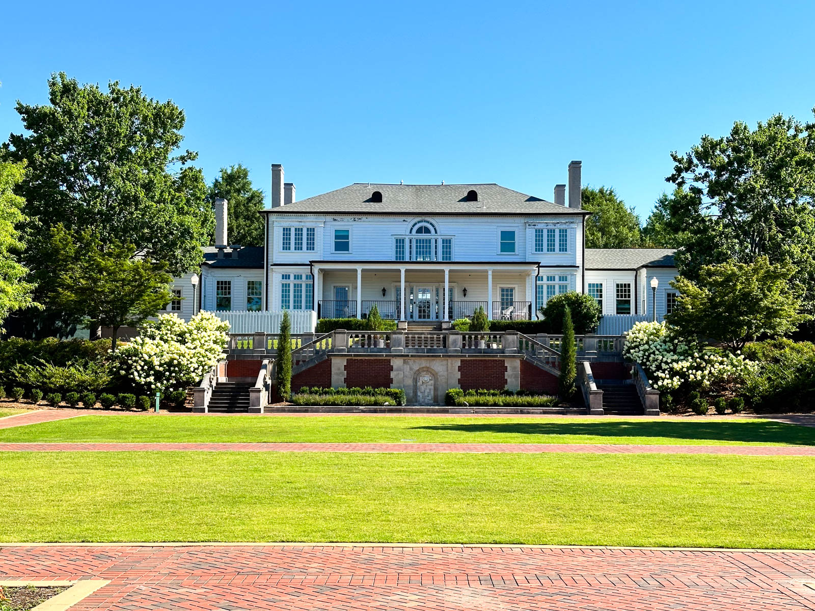 A white building on campus with lots of steps.