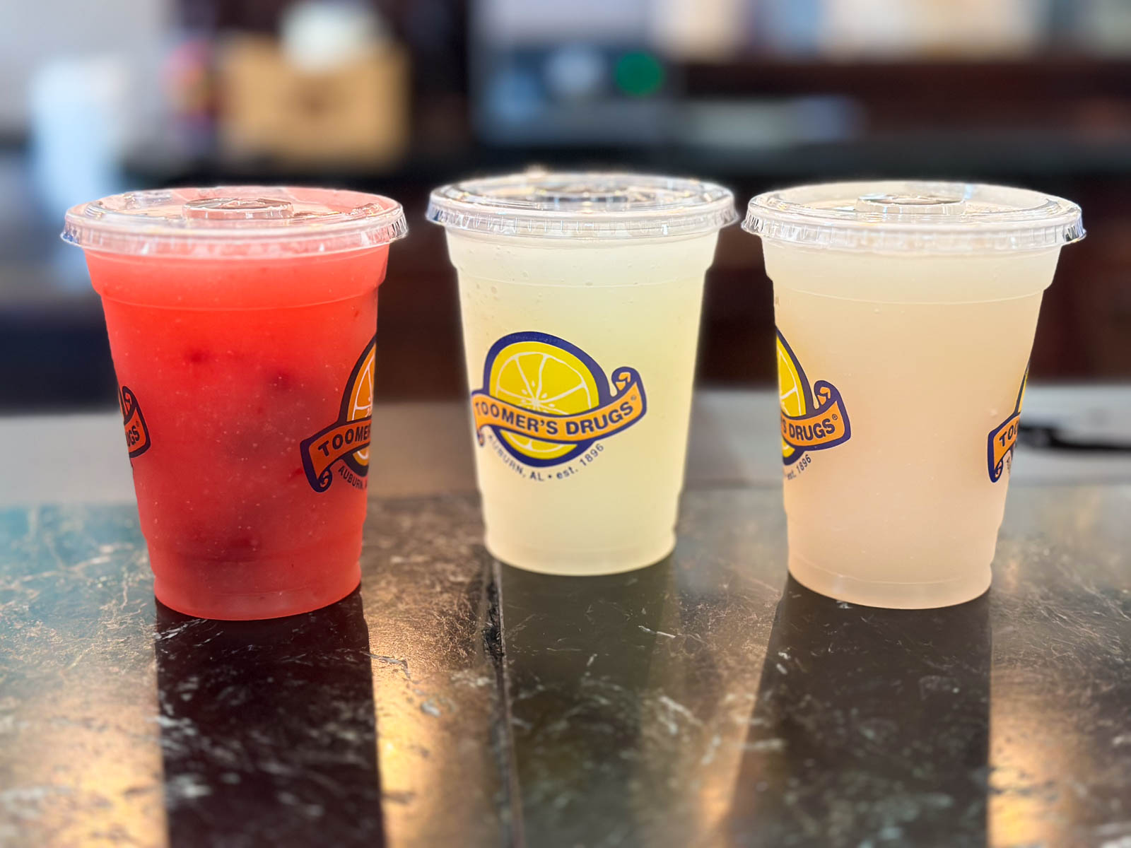 Three cups of iced lemonade in a row.