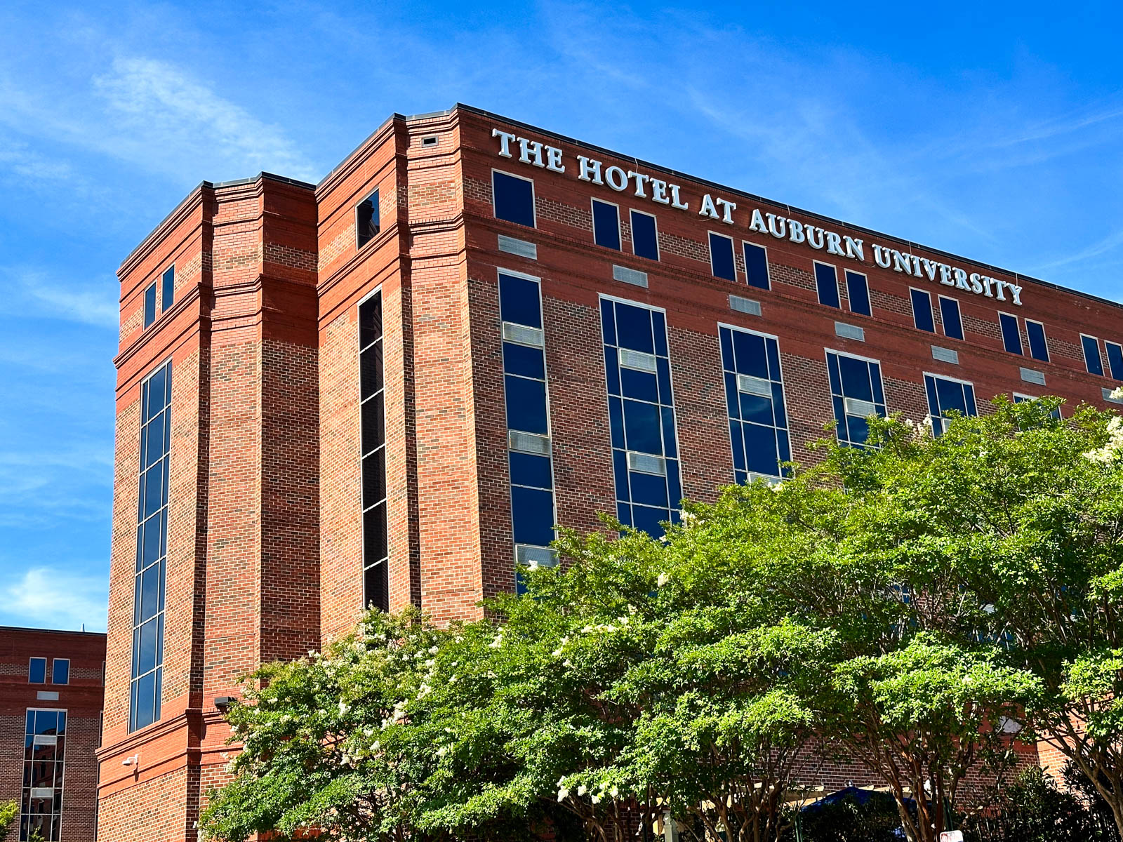 The outside of the hotel against a bright blue sky.