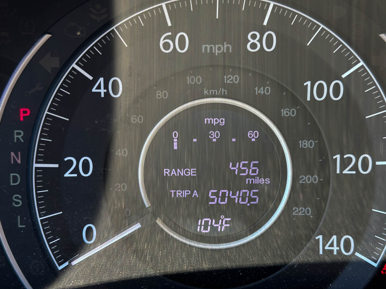 A car's dashboard shows the hot temperature