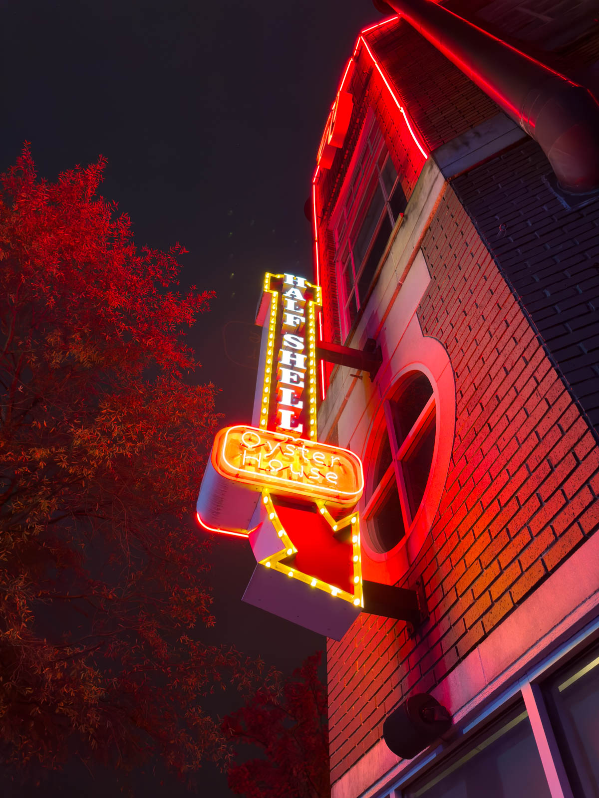 The neon sign outside the restaurant is red and gold.