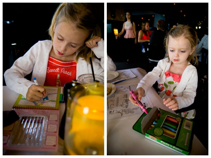 Two young girls are dressed up for a fancy restaurant dinner.