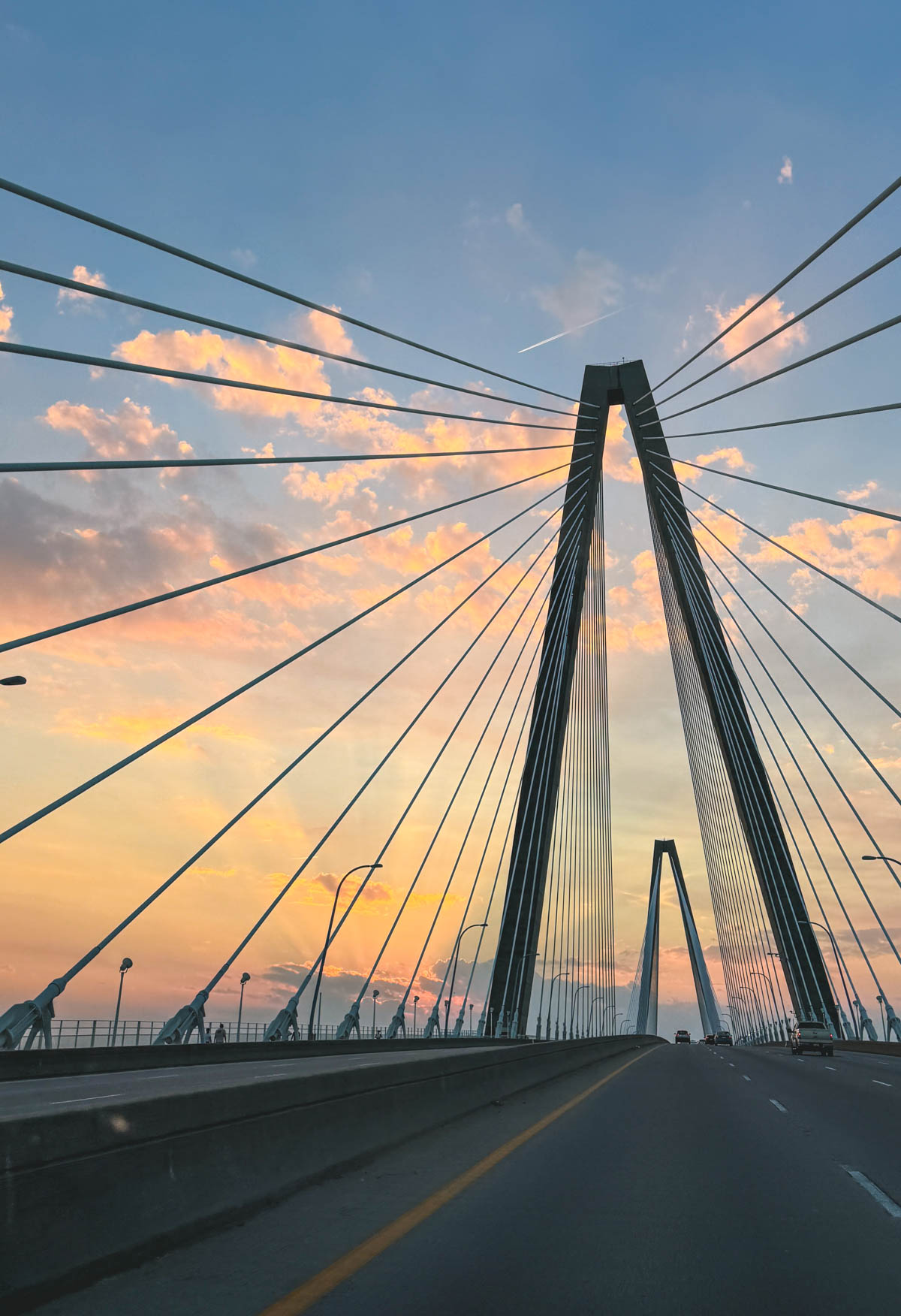 The grand sweeping lines of the Ravenel bridge against the sunset.
