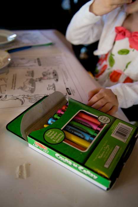 A package of crayons sits on a restaurant table.