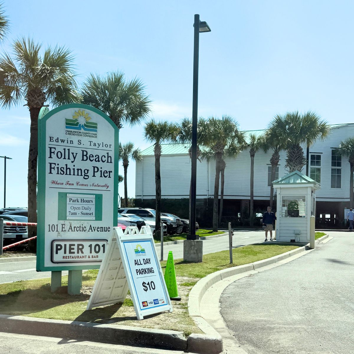 The parking sign at the Folly Beach fishing pier parking lot.
