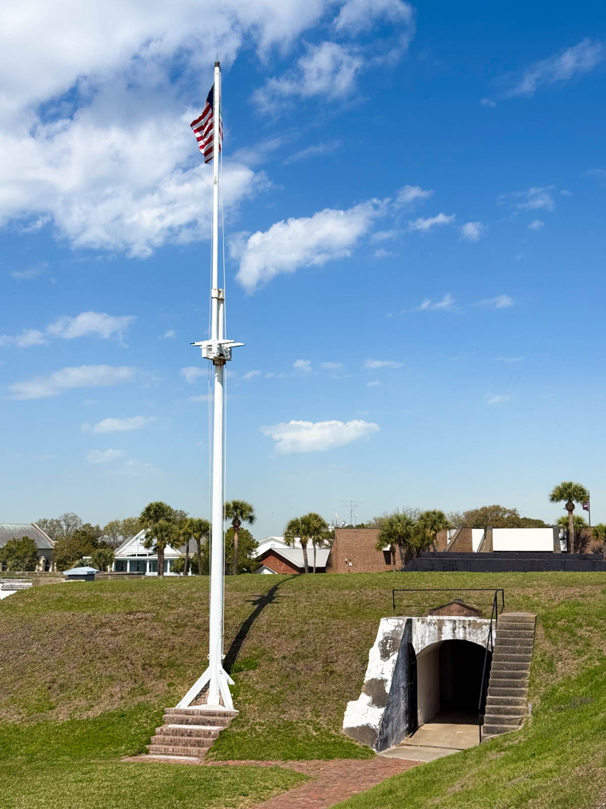 The tunnel opening of the entrance to the fort with an American flag at full mast.