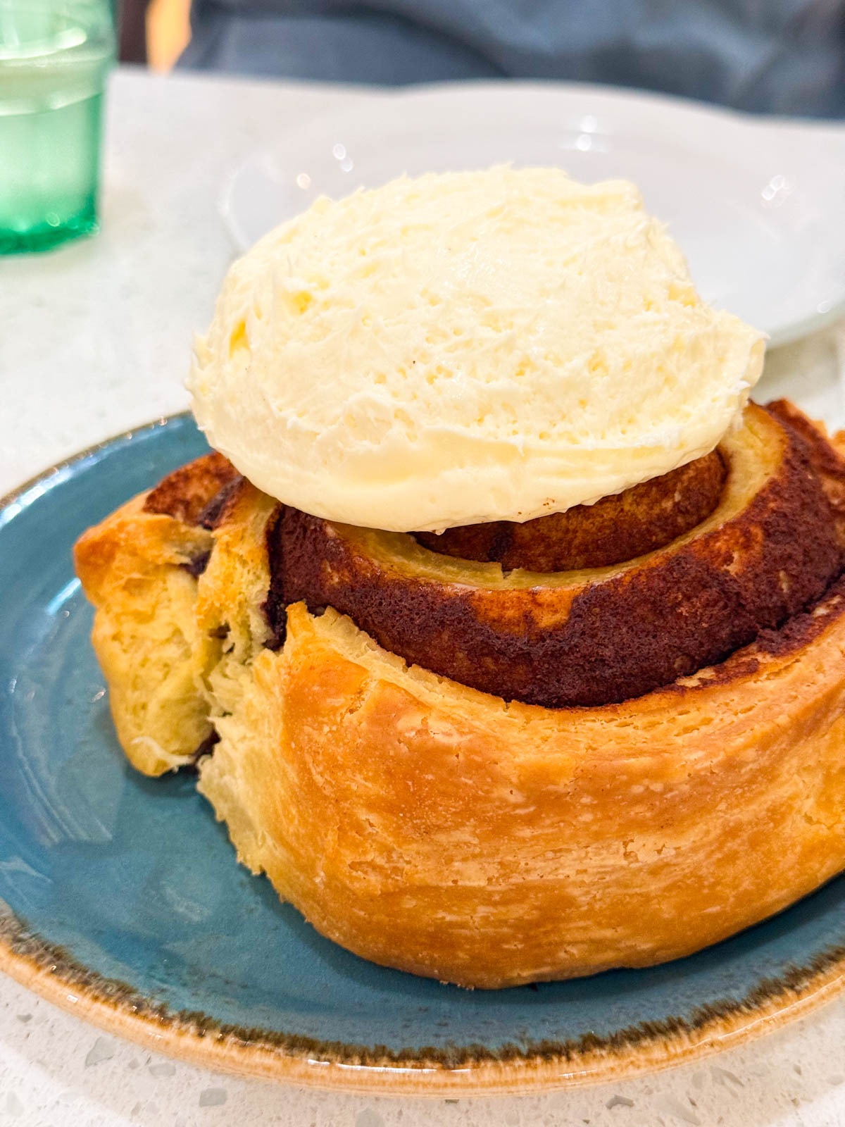 A giant cinnamon roll on a plate.