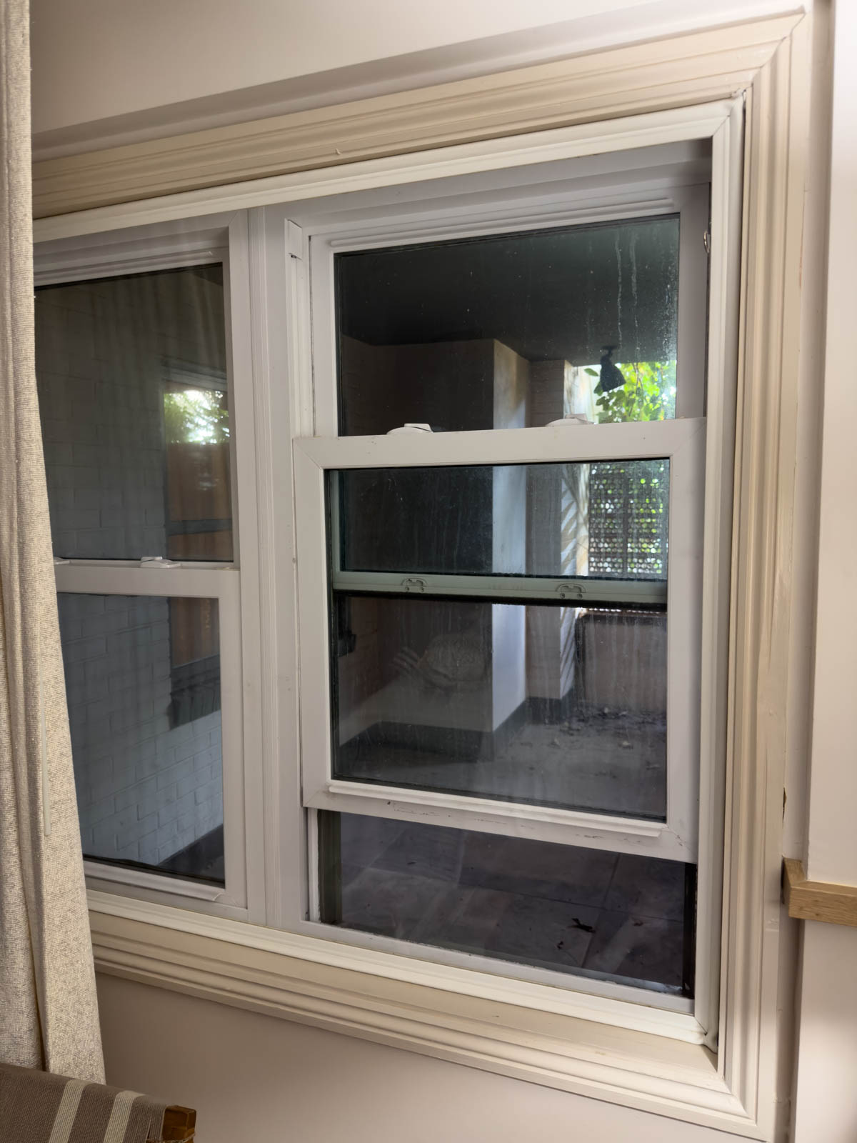 The window view is a dark, dirty open corridor.
