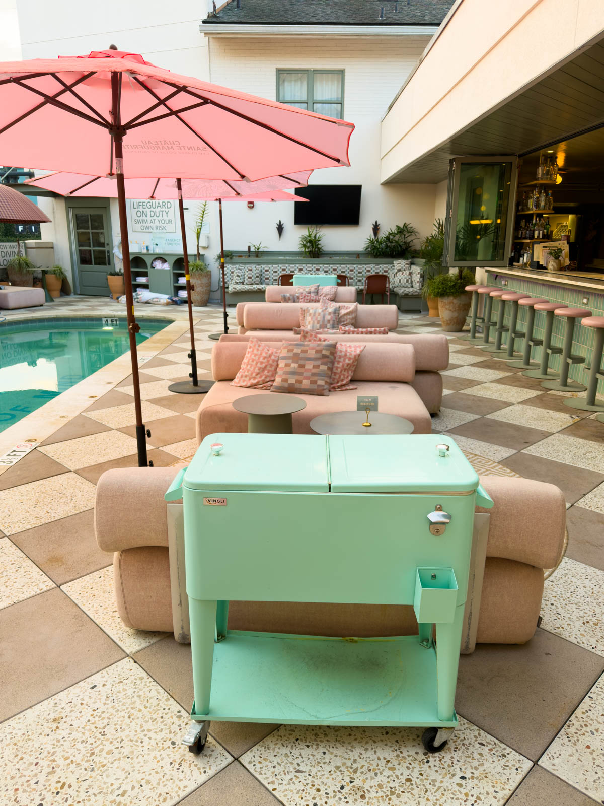The cushioned loungers by the pool.