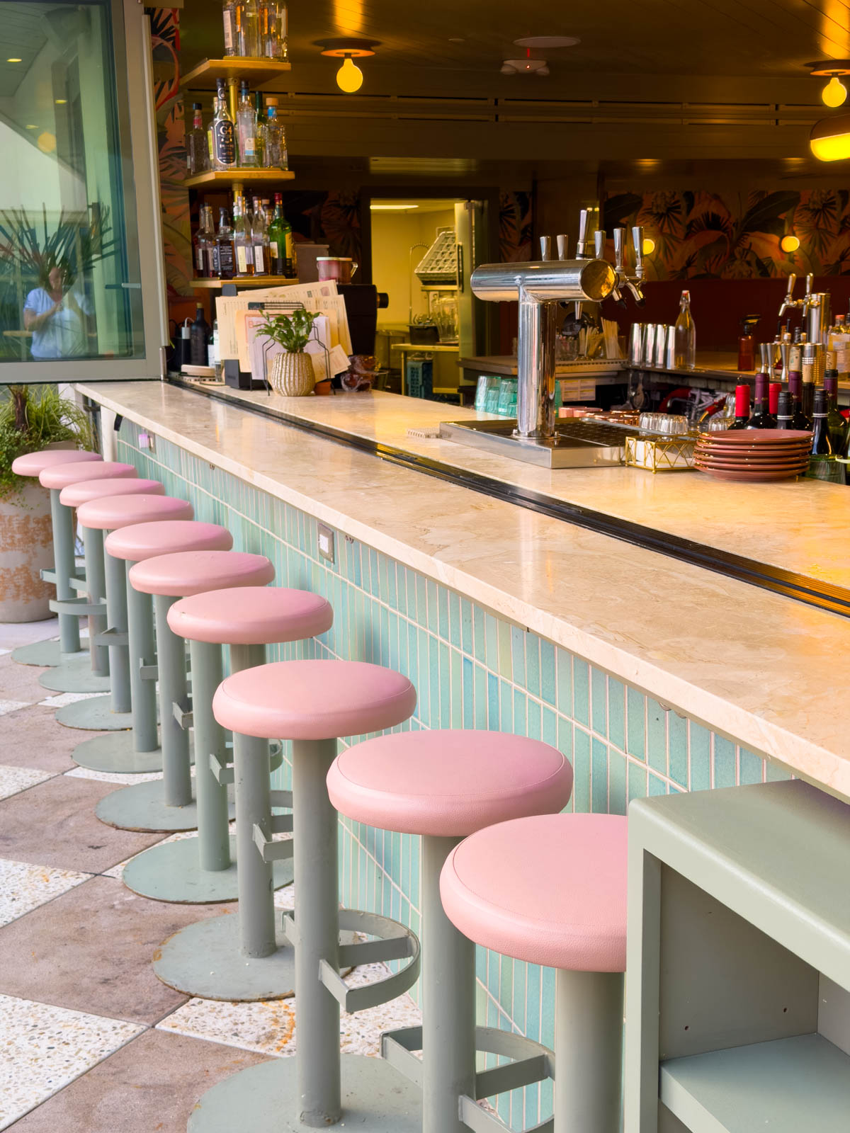 The bar stools lined up at the counter.