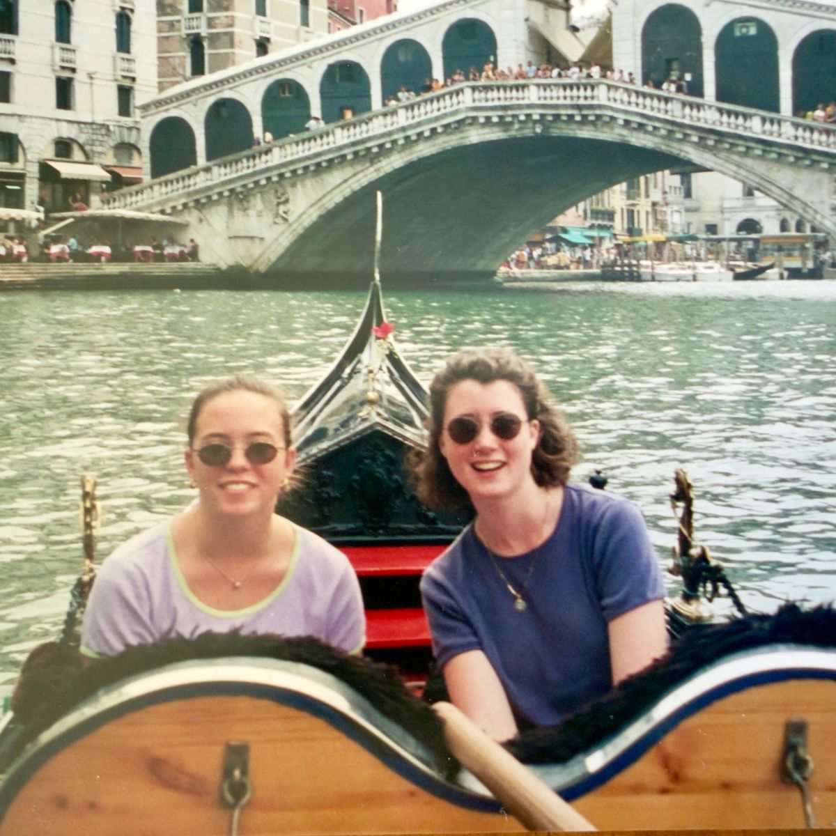 A vintage photo of two young women riding a gondola in Venice.