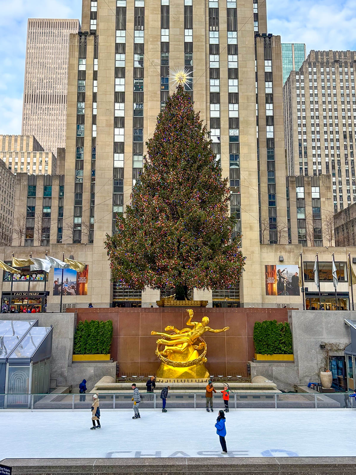 The Rockefeller Christmas tree is seen in the morning with skaters on the ice rink down below. 