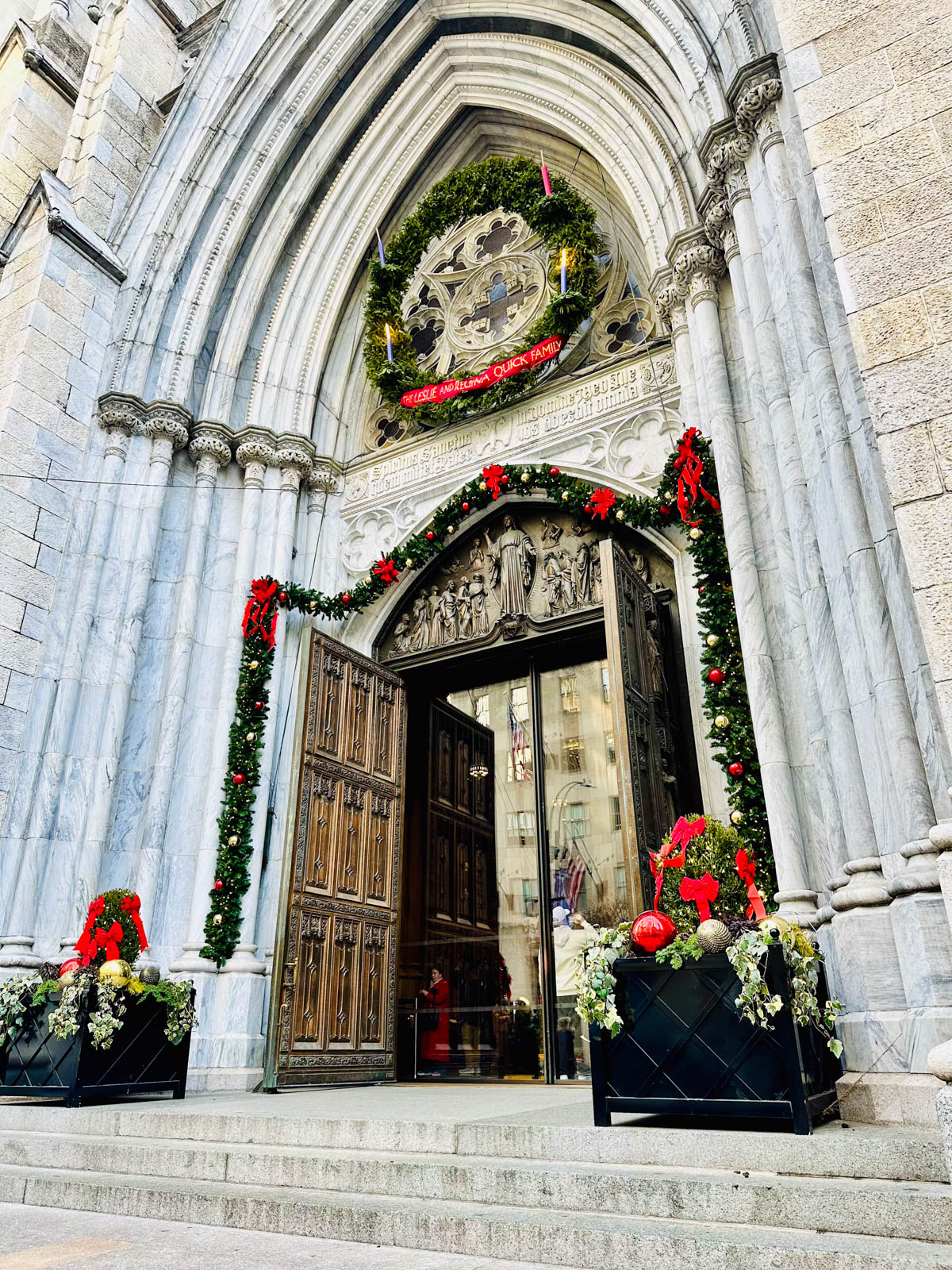 The entrance to St. Patrick's Cathedral in New York is decorated with Christmas garlands and wreaths. 